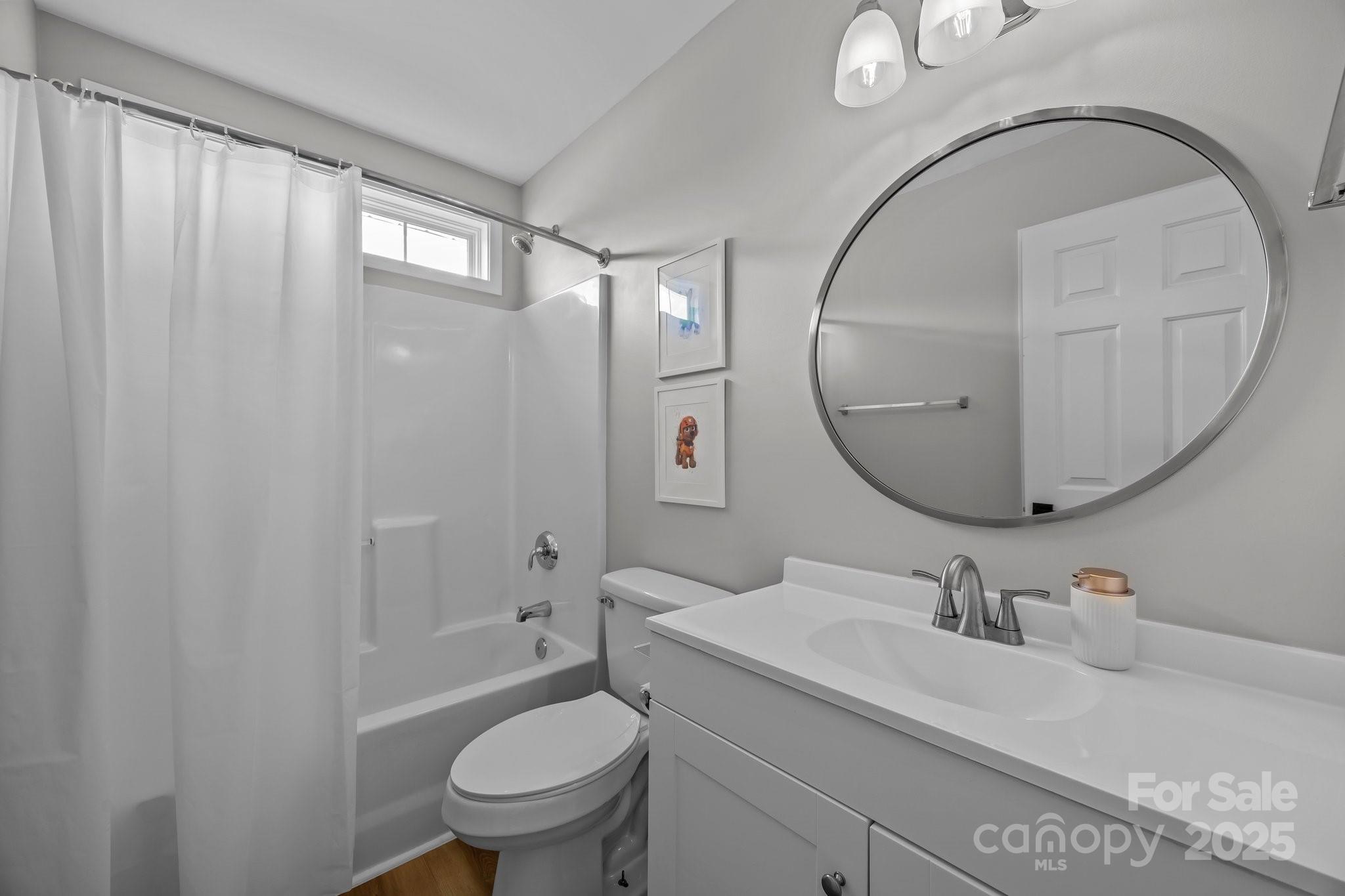 347 Wildbriar Road, Unit 28 Fletcher, NC 28732 - Photo 33 of 43 a bathroom with a sink a toilet and a mirror