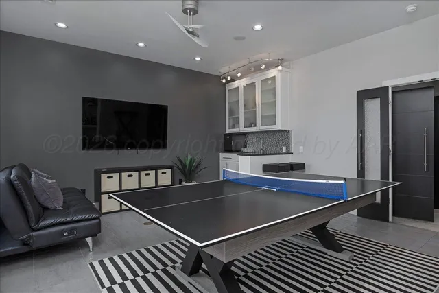 a bathroom with a granite countertop toilet a sink and a mirror
