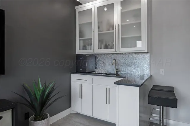 a large bed sitting in a bedroom next to a window