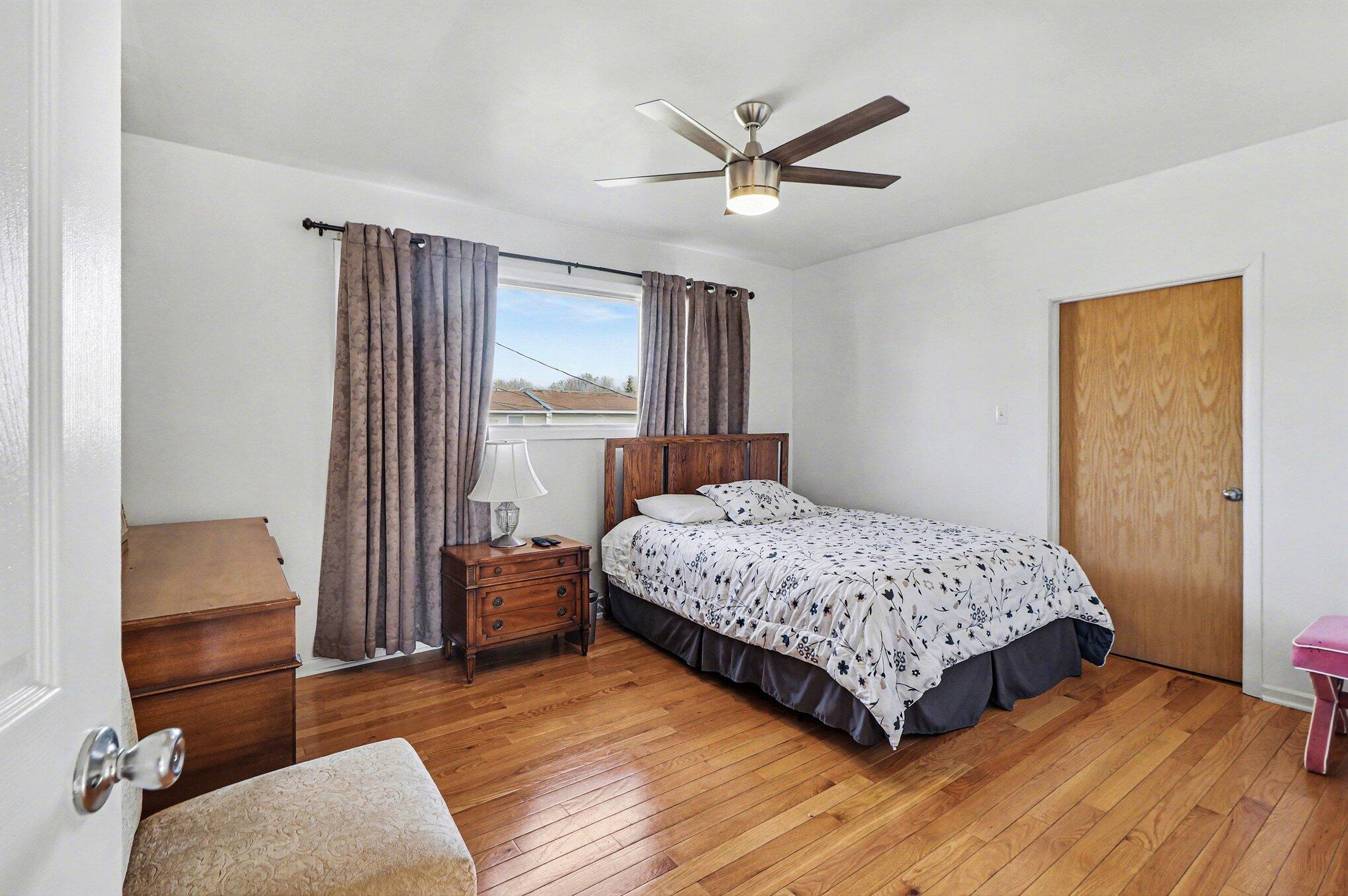 551 Union Place Gary, IN 46403 - Photo 25 of 28 a bedroom with a bed and wooden floor