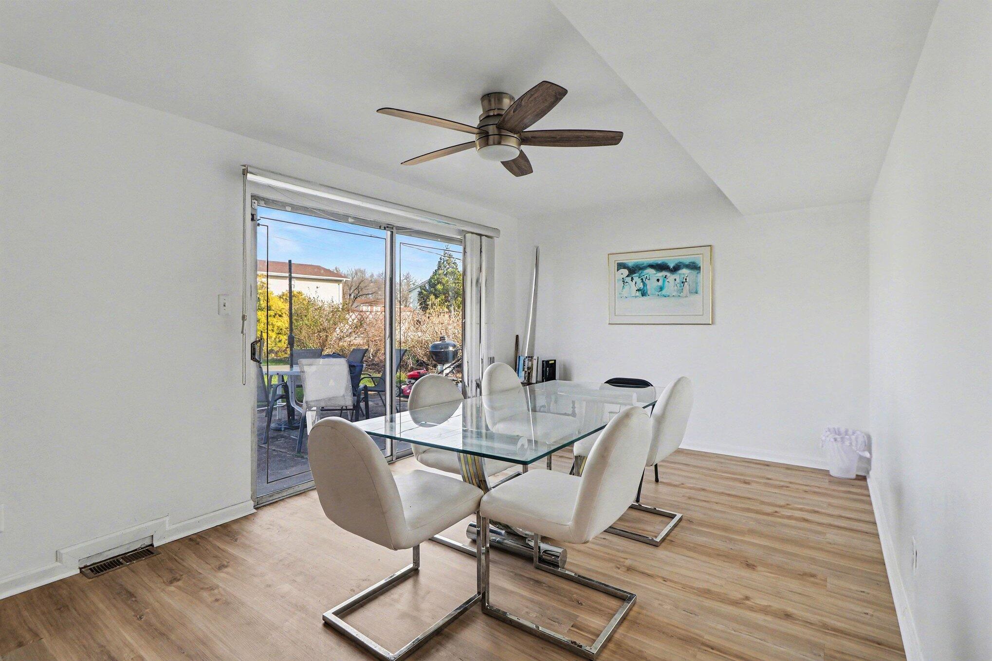 551 Union Place Gary, IN 46403 - Photo 6 of 28 a dining room with wooden floor a glass table and chairs