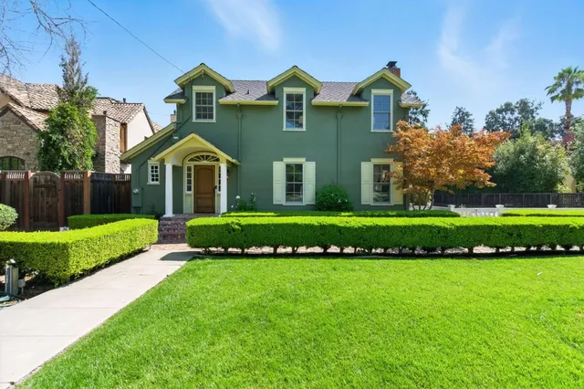 a front view of a house with a garden