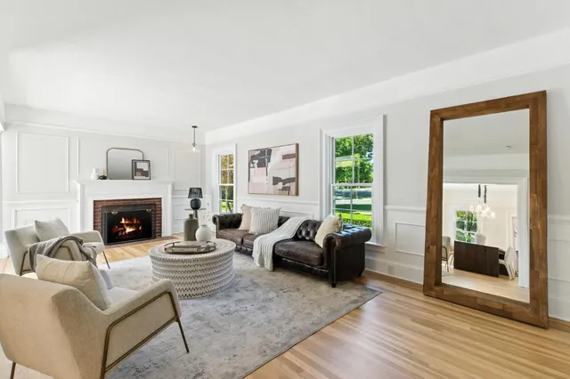 a living room with furniture and a floor to ceiling window