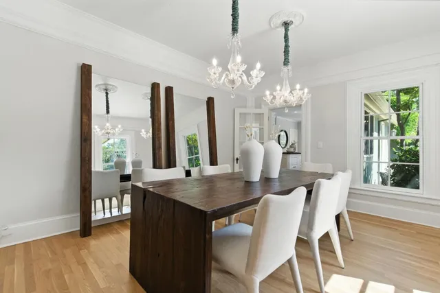 a open dining room with kitchen island a table and chairs