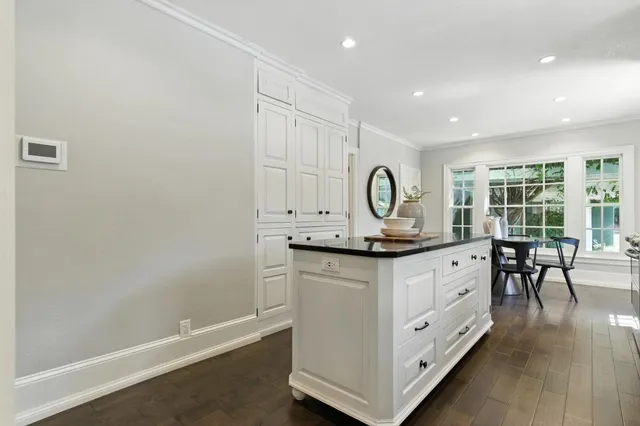 a bathroom with a granite countertop sink a toilet and a mirror