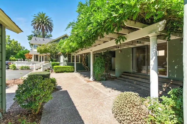 an aerial view of a house with a yard and garden