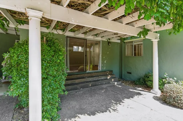 an aerial view of a house with a yard and lake view