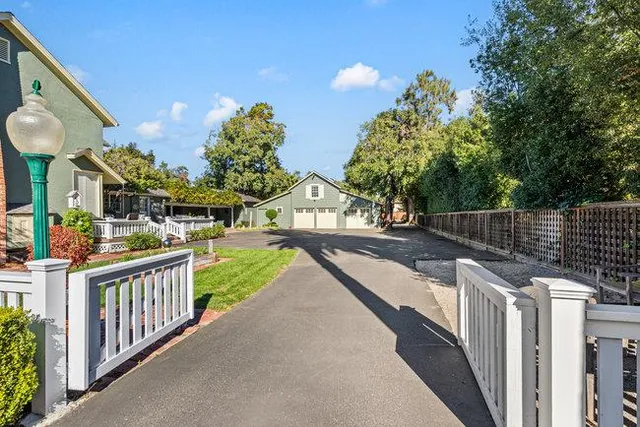 a view of a house with a yard and garage