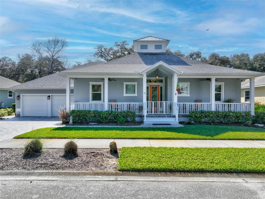 65 Sandy Beach Way Palm Coast, FL 32137 - Photo 2 of 85 a front view of a house with a yard and garage