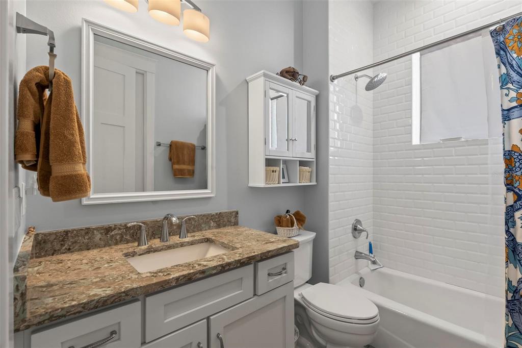 65 Sandy Beach Way Palm Coast, FL 32137 - Photo 29 of 85 a bathroom with a granite countertop sink toilet and shower