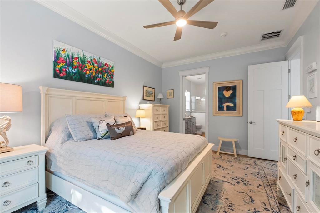 65 Sandy Beach Way Palm Coast, FL 32137 - Photo 62 of 85 a bedroom with a large bed and a chandelier