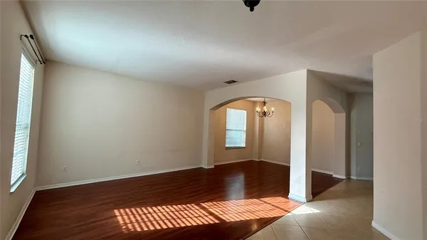 a view of a room with wooden floor