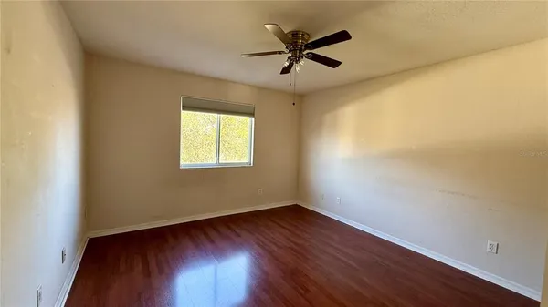 a view of a room with wooden floor and a window