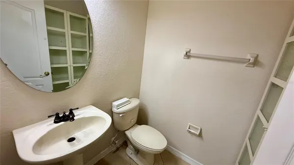a bathroom with a sink mirror and toilet