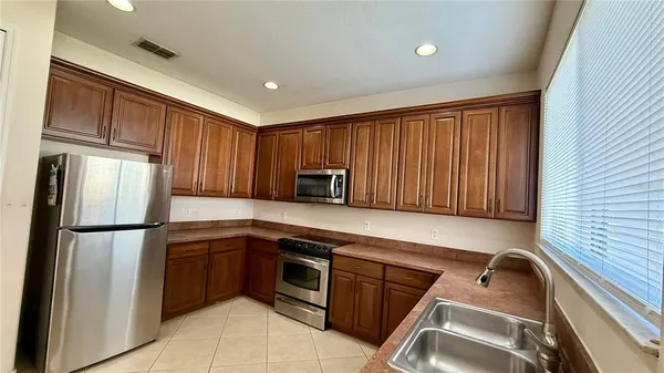 a kitchen with stainless steel appliances granite countertop a refrigerator sink and cabinets