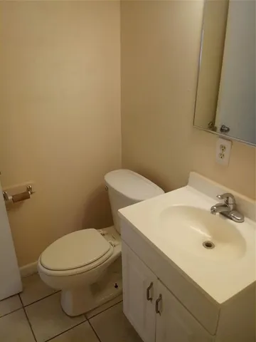 a white toilet sitting next to a bathroom sink