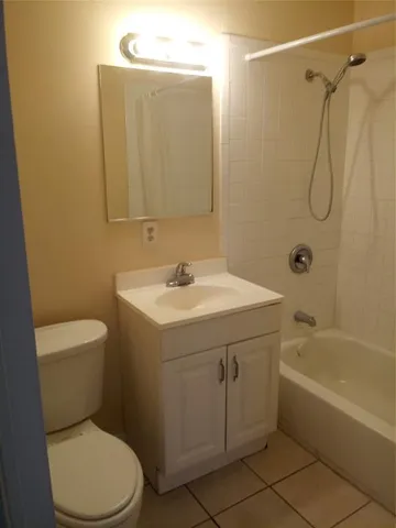 a bathroom with a sink mirror vanity and toilet