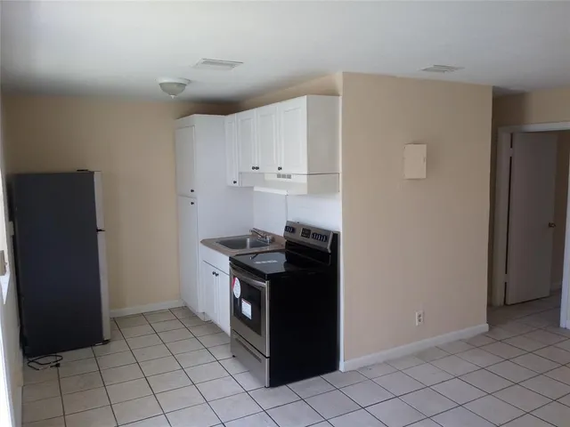 a kitchen with granite countertop a refrigerator and a stove