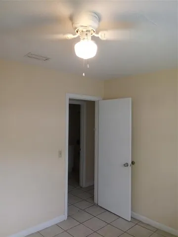 a view of a chandelier fan and entryway