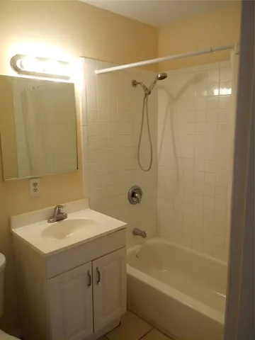 a bathroom with a sink a mirror and a bathtub