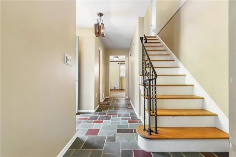 a view of an entryway with wooden floor