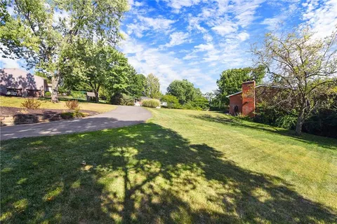 a view of yard with swimming pool and green space