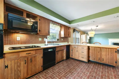 a kitchen with stainless steel appliances granite countertop a stove microwave and sink