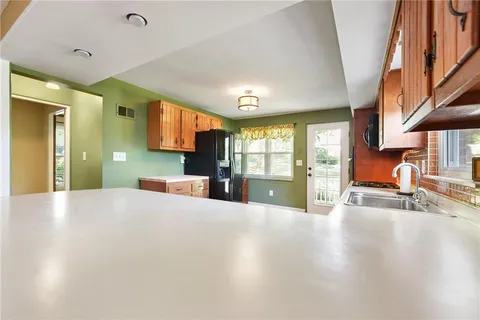 a view of a kitchen with a sink and cabinets
