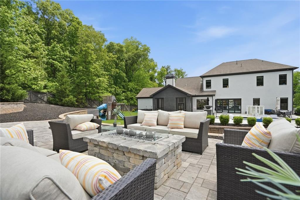 3020 Wallace Road Buford, GA 30519 - Photo 56 of 66 a view of a patio with couches chairs and a fire pit