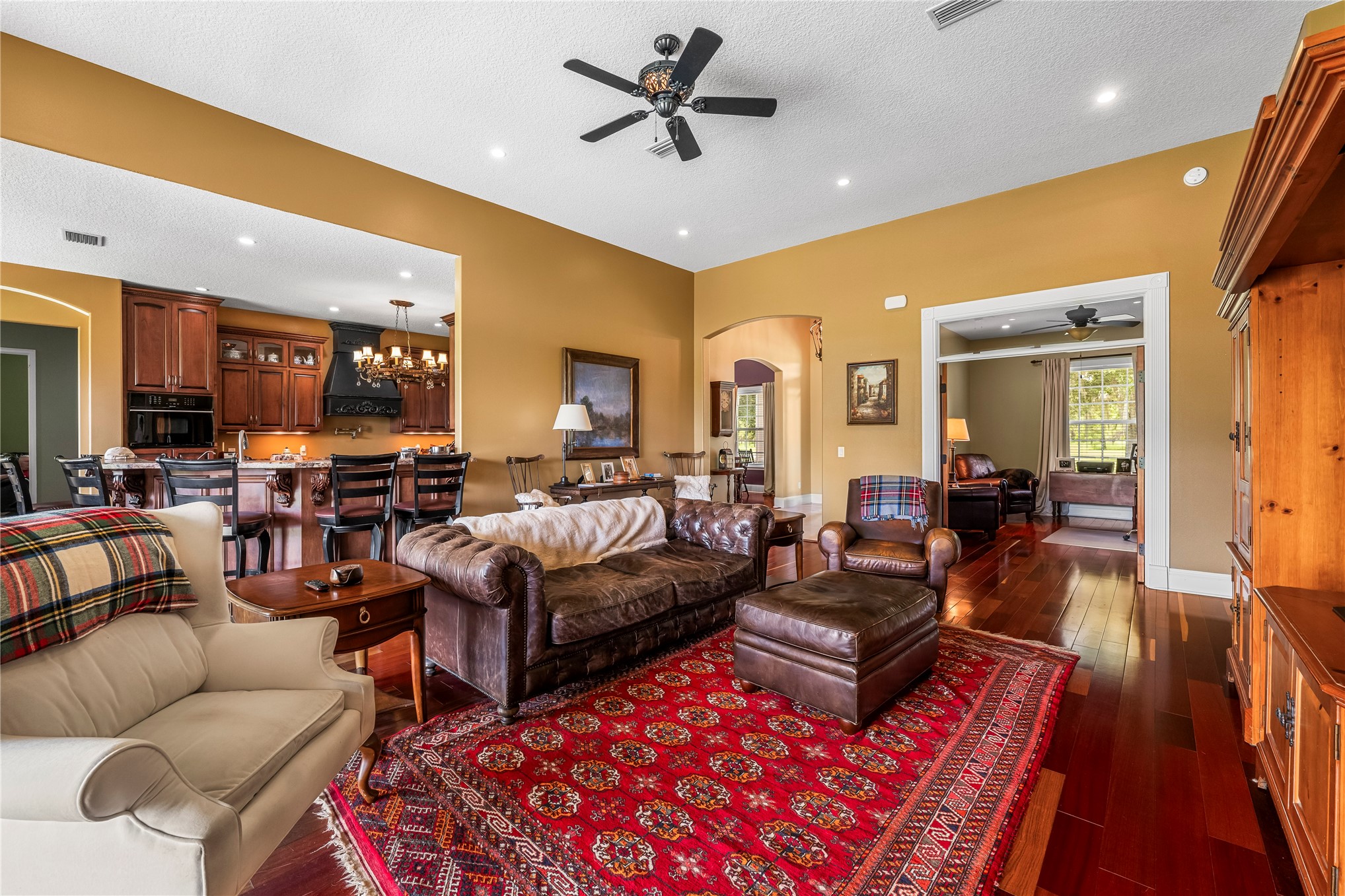 27247 Hallman Road Hilliard, FL 32046 - Photo 27 of 59 a living room with furniture ceiling fan and a rug