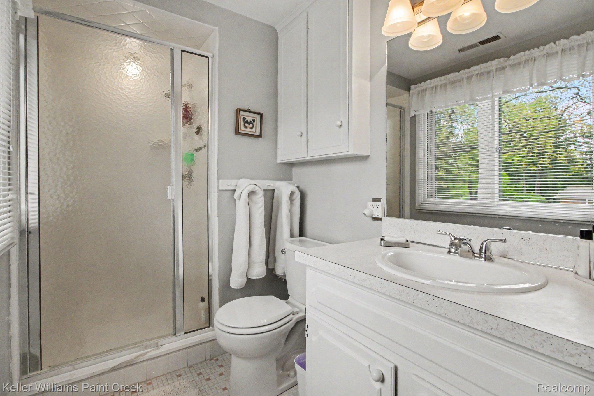3370 Aquinas Drive Rochester, MI 48309 - Photo 14 of 25 Bathroom with vanity, a stall shower, and light tile patterned floors