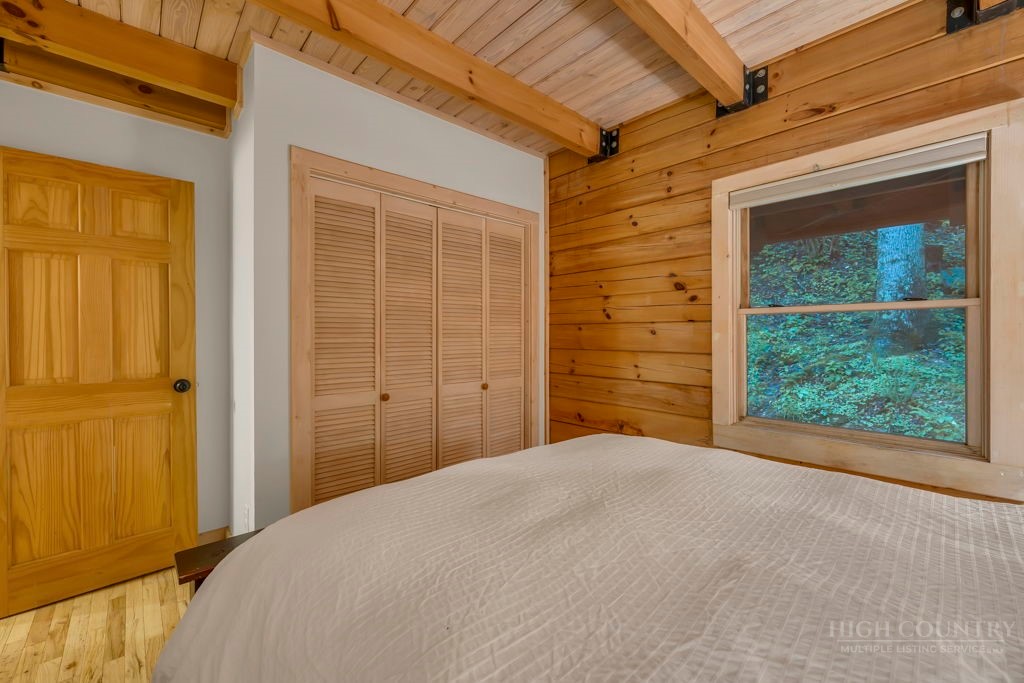 192 Dewitt Barnett Road Vilas, NC 28692 - Photo 19 of 32 a bedroom with a bed and a window