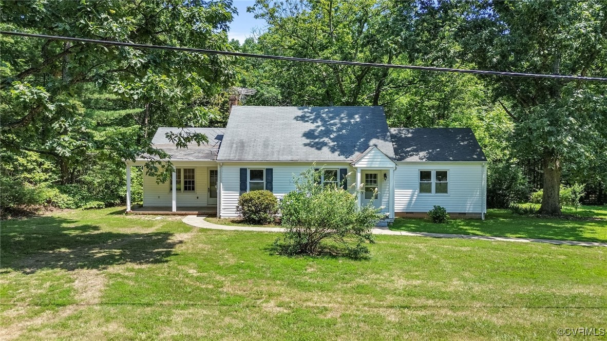 a view of a house with a big yard and potted plants
