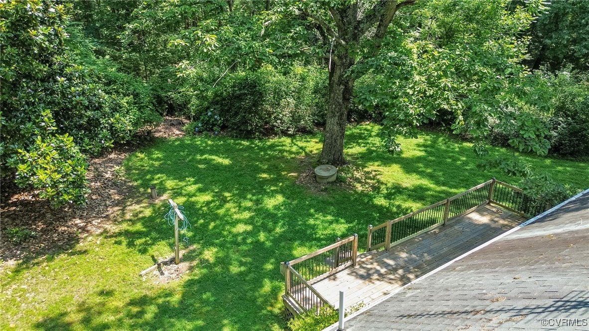 2812 Chapel Road New Canton, VA 23123 - Photo 26 of 32 a backyard of a house with lots of green space and trees all around