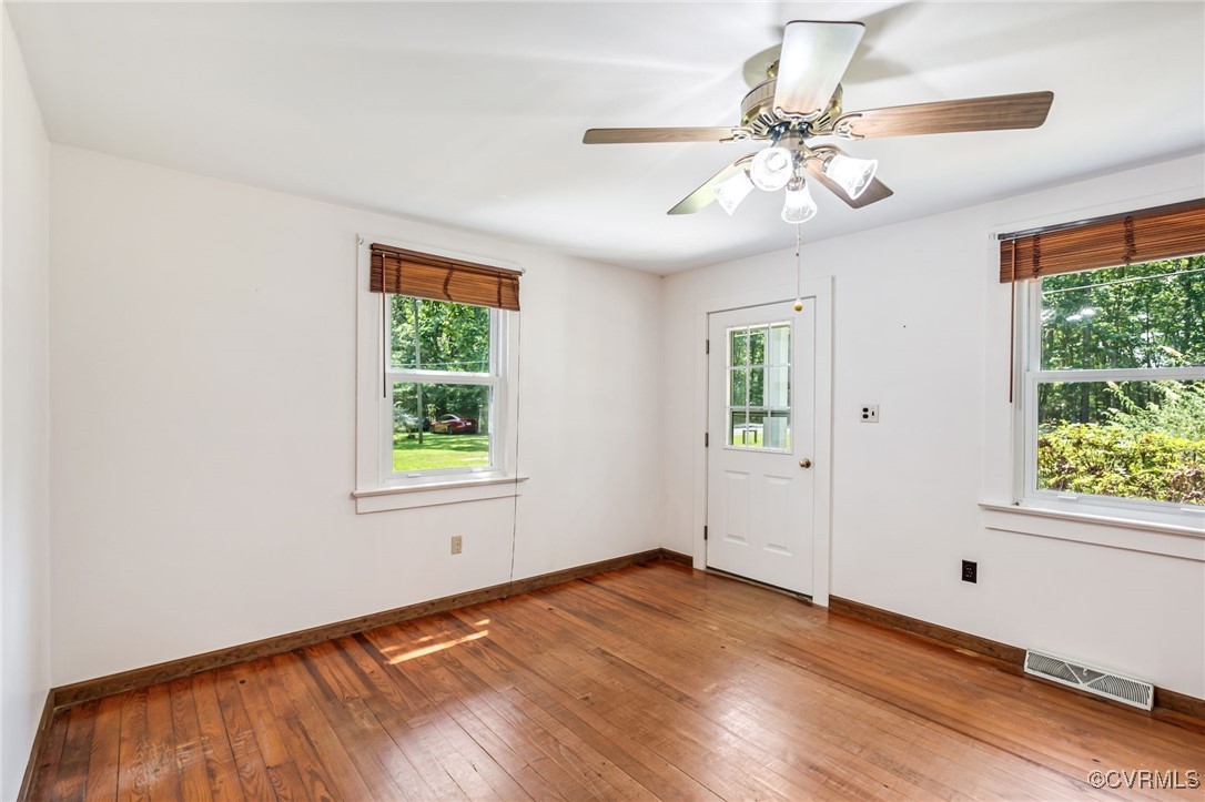 2812 Chapel Road New Canton, VA 23123 - Photo 6 of 32 an empty room with wooden floor fan and windows