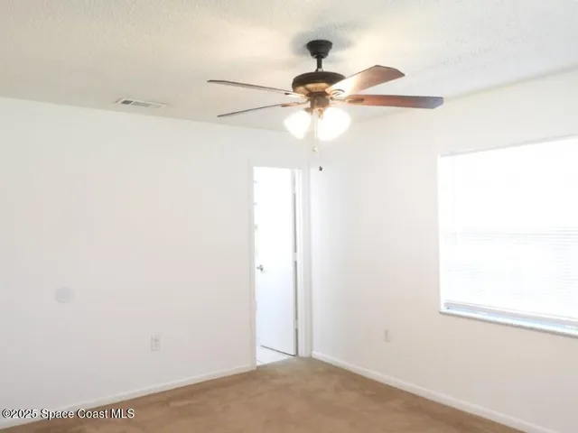 a view of a small space with a fan