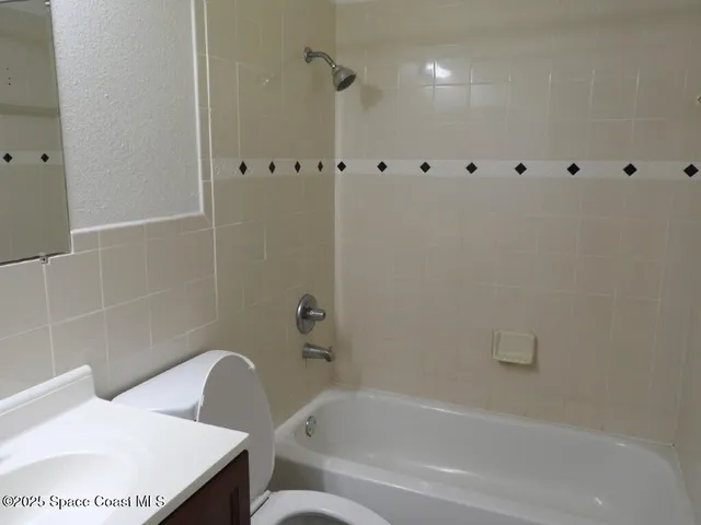 a bathroom with a bathtub a toilet and a shower