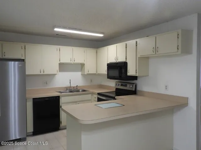 a kitchen with a sink a stove and refrigerator