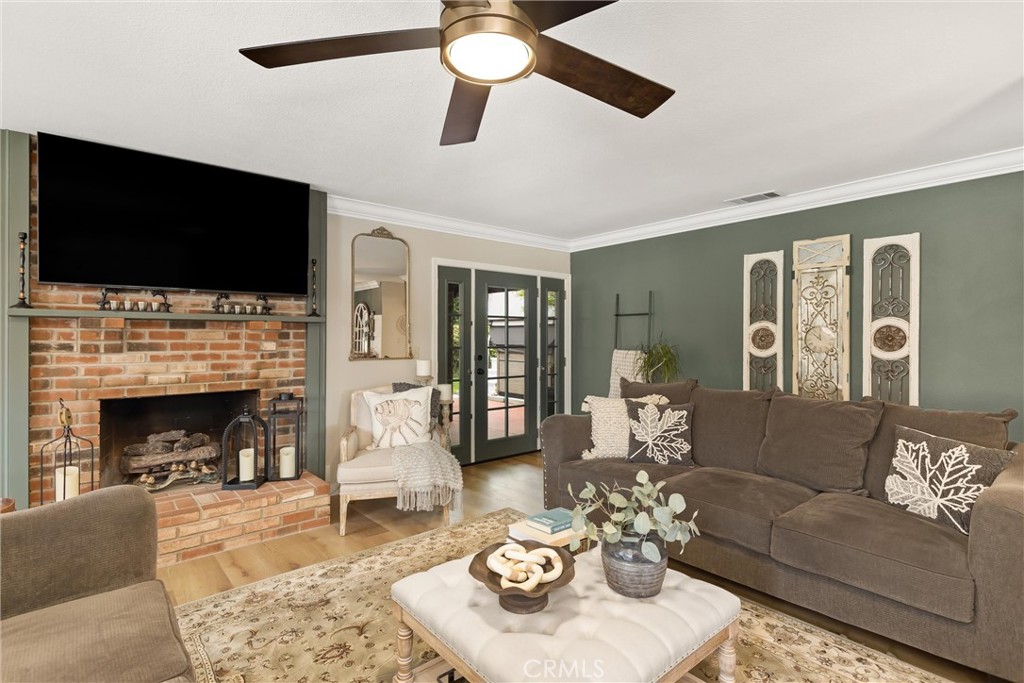 36113 Sharon Way Yucaipa, CA 92399 - Photo 17 of 49 Brick fireplace, TV stays. Exit to rear patio