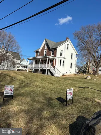 a view of a white house with a yard