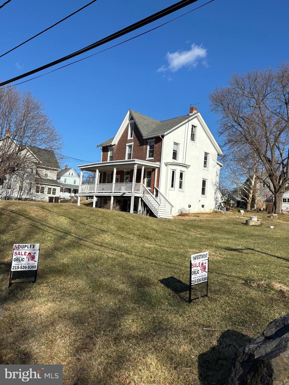 a view of a white house with a yard
