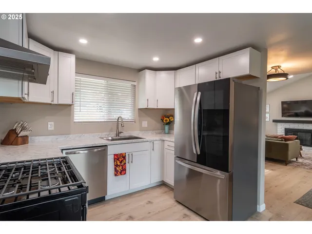 a kitchen with stainless steel appliances a refrigerator and a sink