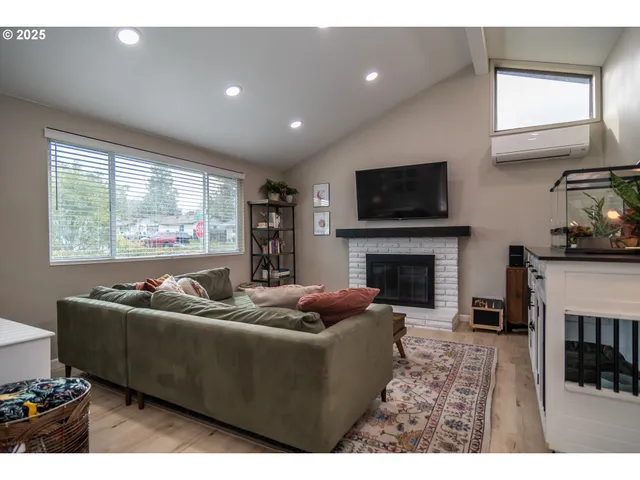 a living room with furniture flat screen tv and a fireplace