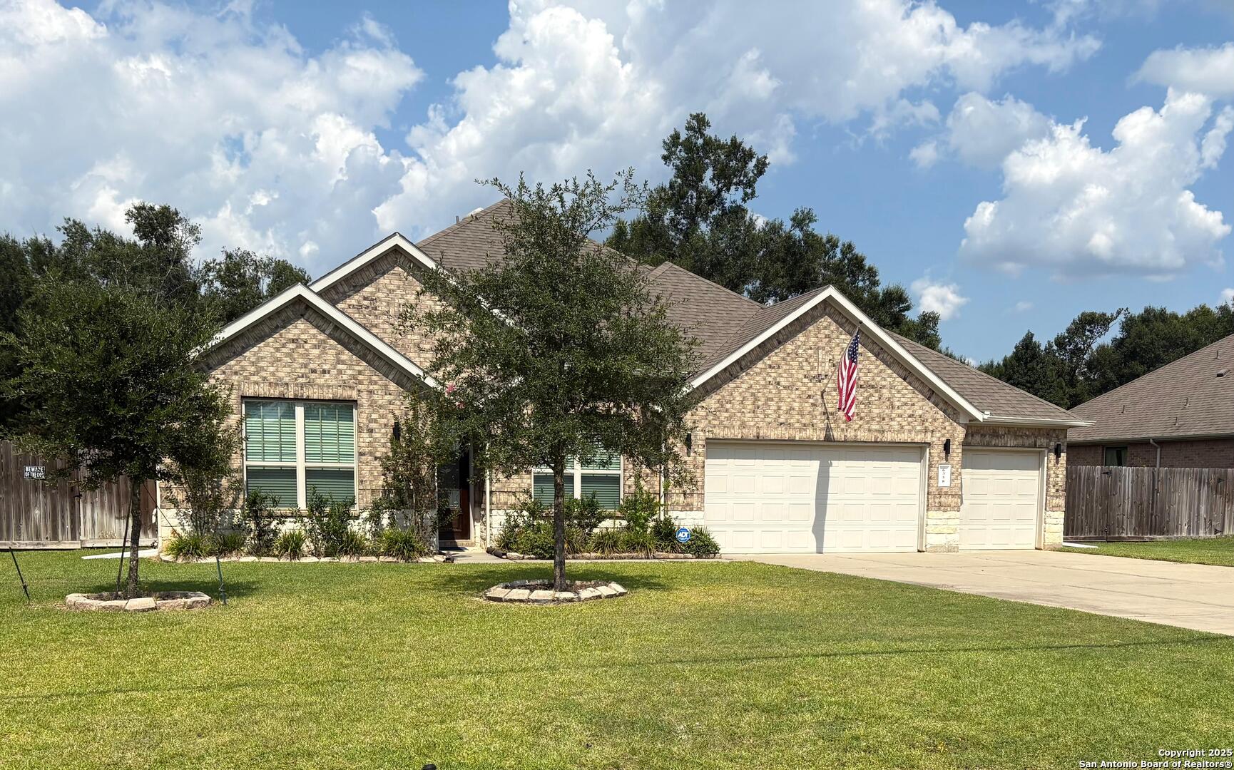 6358 Rolling Hills Road Conroe, TX 77303 - Photo 1 of 23 a front view of a house with a yard and garage