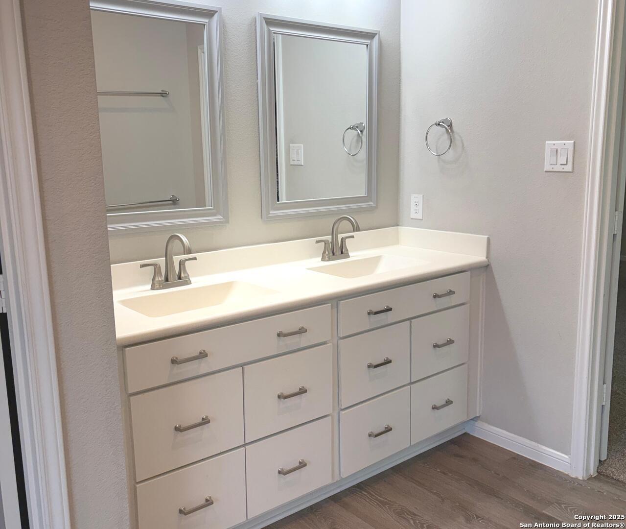6358 Rolling Hills Road Conroe, TX 77303 - Photo 11 of 23 a bathroom with a double vanity sink and mirror