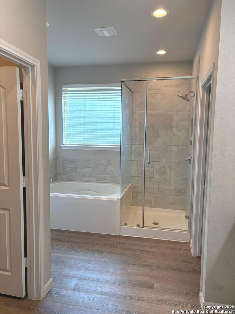 6358 Rolling Hills Road Conroe, TX 77303 - Photo 12 of 23 a bathroom with a bathtub and a shower