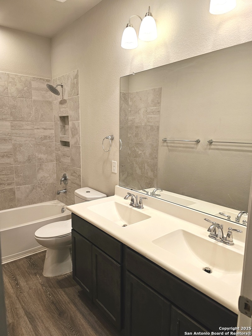 6358 Rolling Hills Road Conroe, TX 77303 - Photo 13 of 23 a bathroom with a sink a toilet and shower