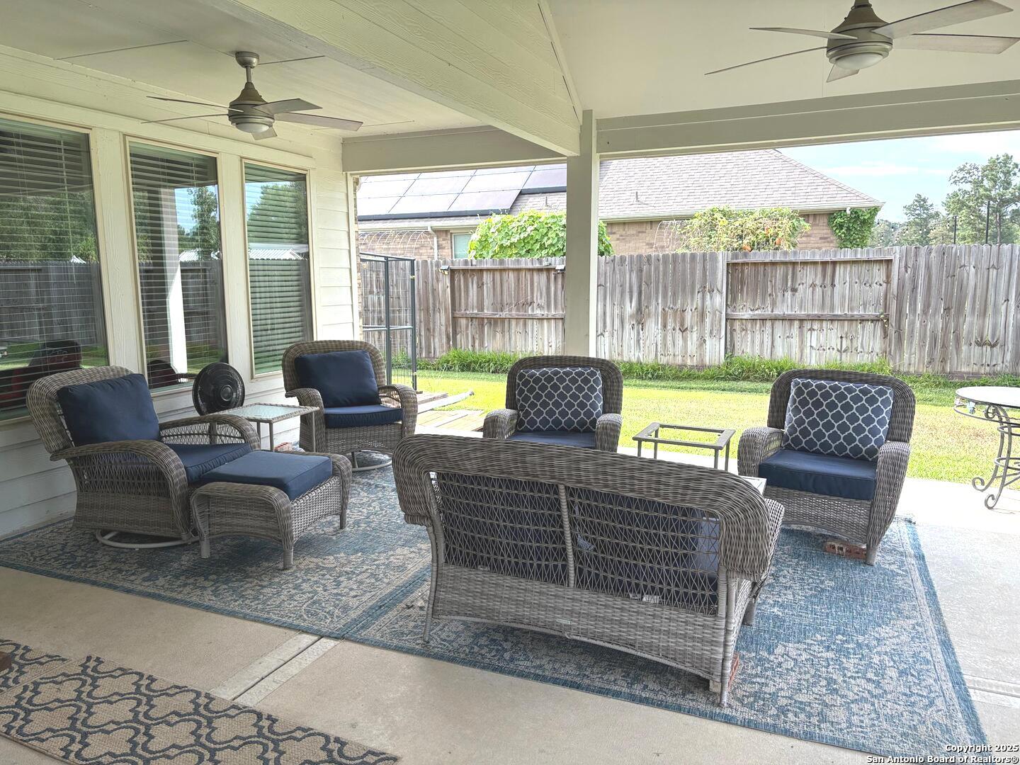 6358 Rolling Hills Road Conroe, TX 77303 - Photo 15 of 23 a living room with furniture and a floor to ceiling window