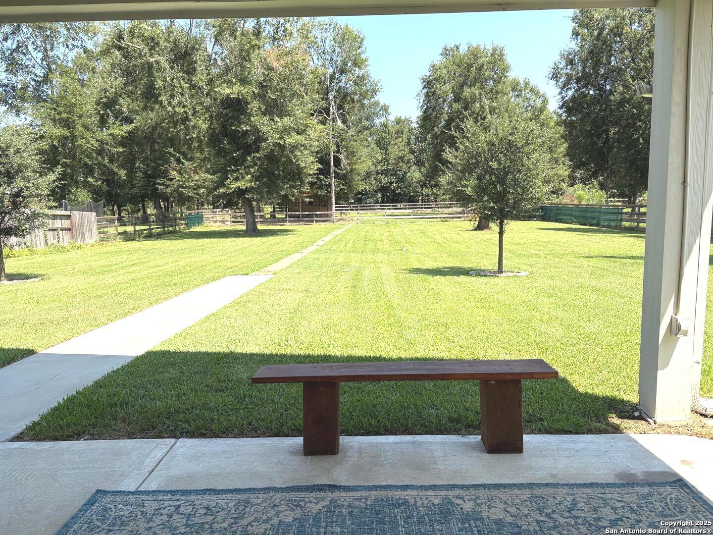 6358 Rolling Hills Road Conroe, TX 77303 - Photo 20 of 23 a view of a swimming pool with a yard