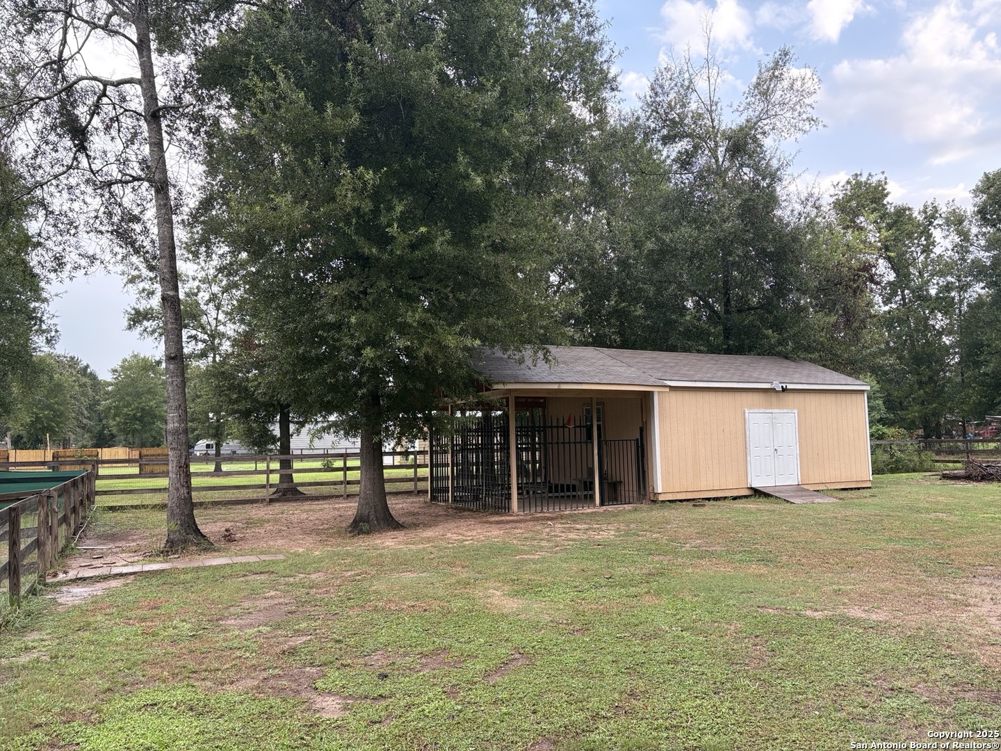 6358 Rolling Hills Road Conroe, TX 77303 - Photo 22 of 23 a view of an house with backyard and trees